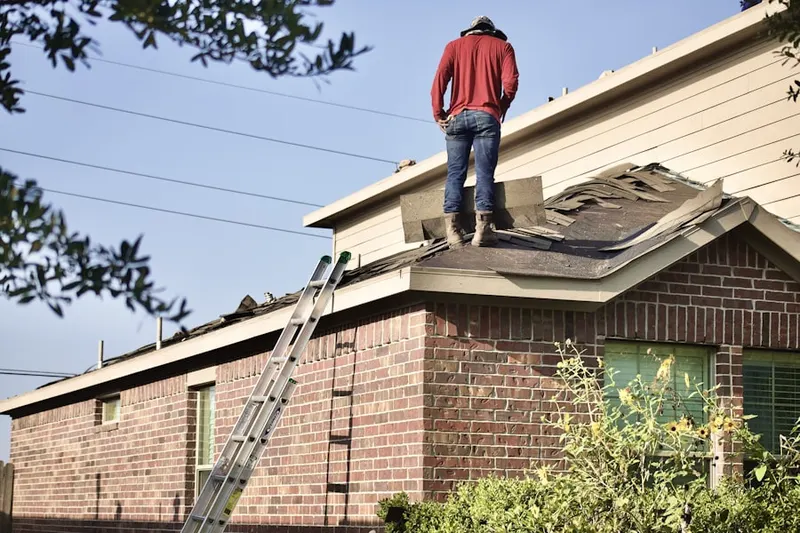 Professional roofer working on a residential roof in Thunderbird Palms-Hickory Shadows